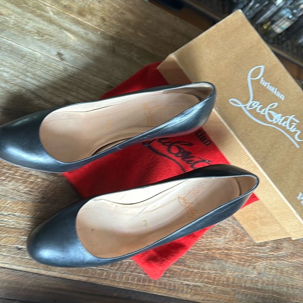 Black Louboutin round toe pumps